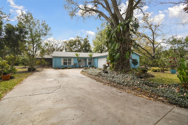 view of front of house featuring concrete driveway and a garage