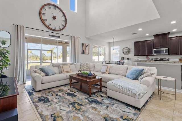 living room featuring recessed lighting, a high ceiling, and light tile patterned floors