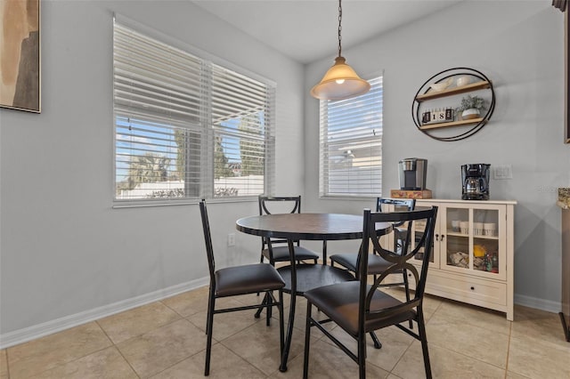 dining space with light tile patterned flooring and baseboards