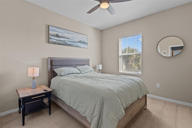 bedroom with baseboards, a ceiling fan, and light colored carpet