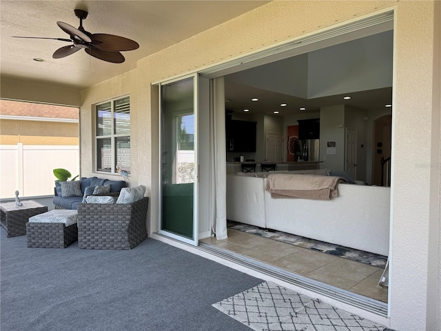 view of patio / terrace with ceiling fan, fence, and an outdoor hangout area