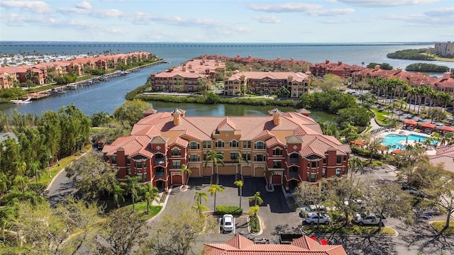 birds eye view of property with a water view and a residential view