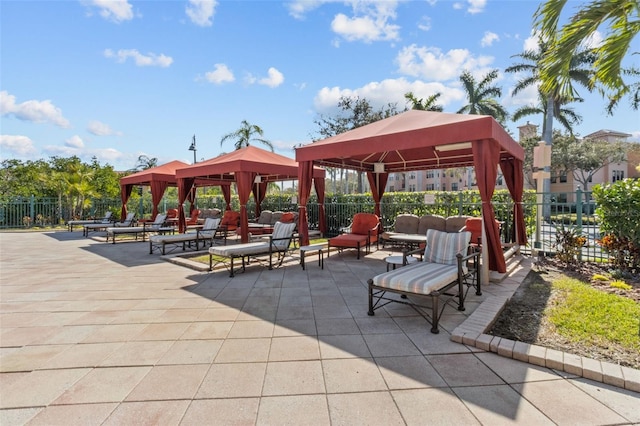 surrounding community with a patio, a gazebo, and fence