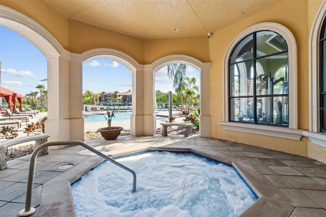 view of pool featuring a patio area and a hot tub