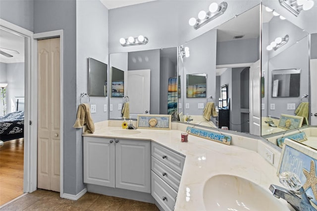 ensuite bathroom featuring double vanity, visible vents, tile patterned floors, ensuite bathroom, and a sink