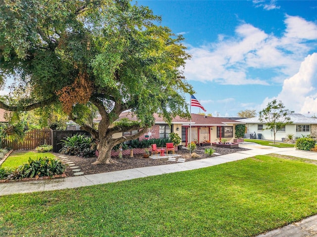 exterior space with driveway, a lawn, and fence