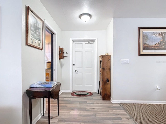 entrance foyer featuring baseboards and wood finished floors