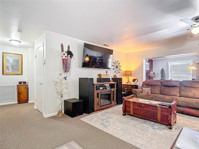 carpeted living area with ceiling fan, visible vents, and baseboards