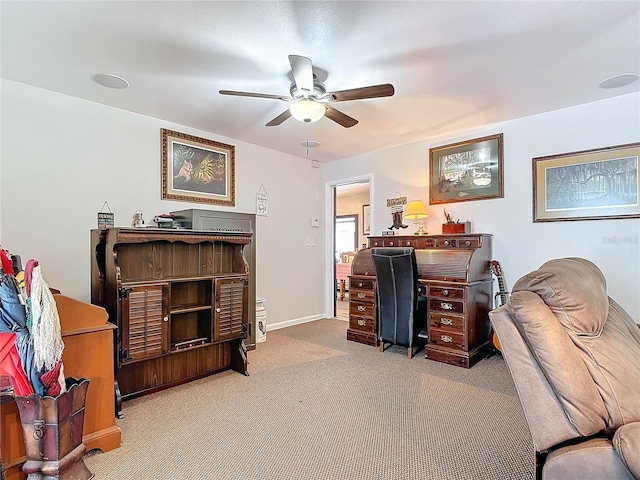 office area with a ceiling fan, carpet flooring, and baseboards