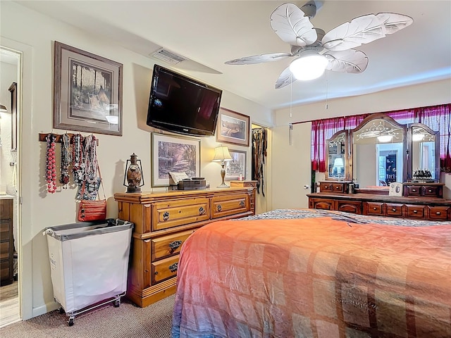 carpeted bedroom with visible vents and ceiling fan