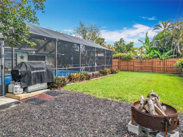 view of yard featuring a fenced in pool, glass enclosure, and a fenced backyard