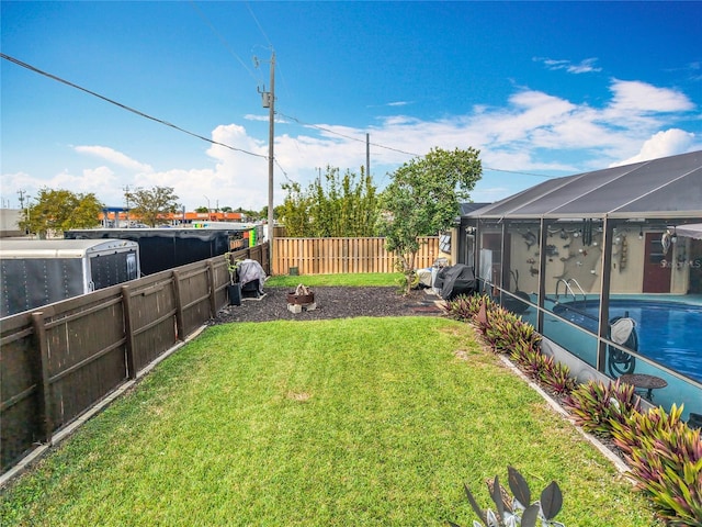 view of yard with glass enclosure, a fenced backyard, and a fenced in pool