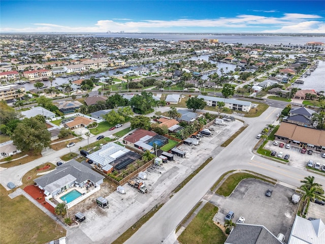 bird's eye view featuring a water view and a residential view