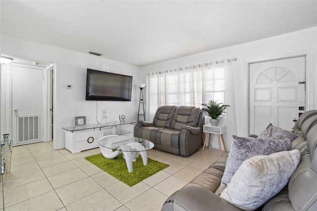 living area with light tile patterned floors and visible vents