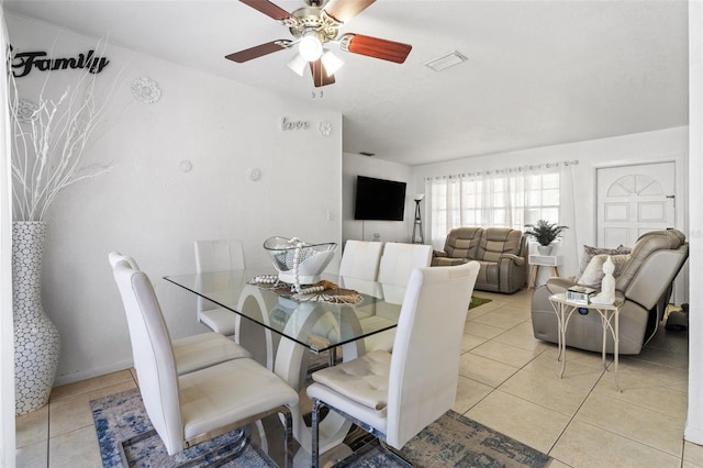 dining space with light tile patterned floors, ceiling fan, and visible vents