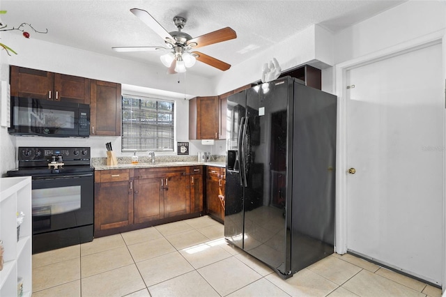 kitchen with light countertops, ceiling fan, black appliances, and light tile patterned floors