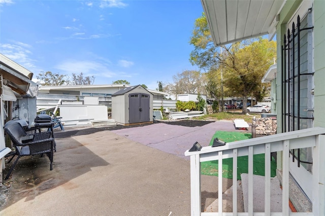 view of patio / terrace featuring an outbuilding and a shed