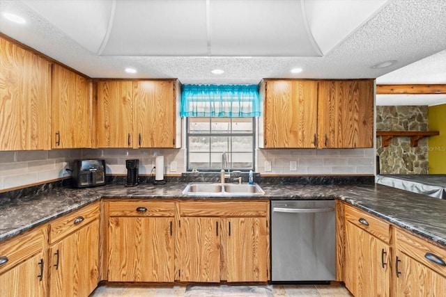 kitchen featuring decorative backsplash, dishwasher, a textured ceiling, and a sink