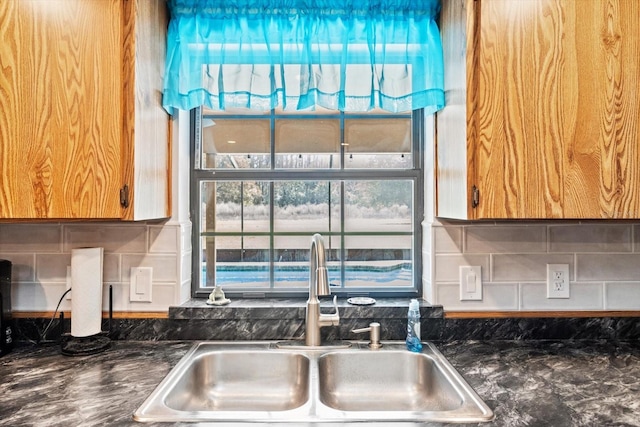 kitchen featuring tasteful backsplash and a sink