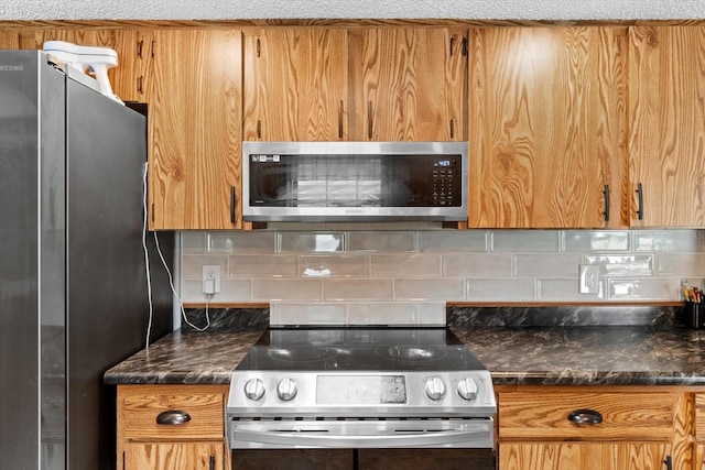 kitchen featuring stainless steel appliances, brown cabinetry, and backsplash