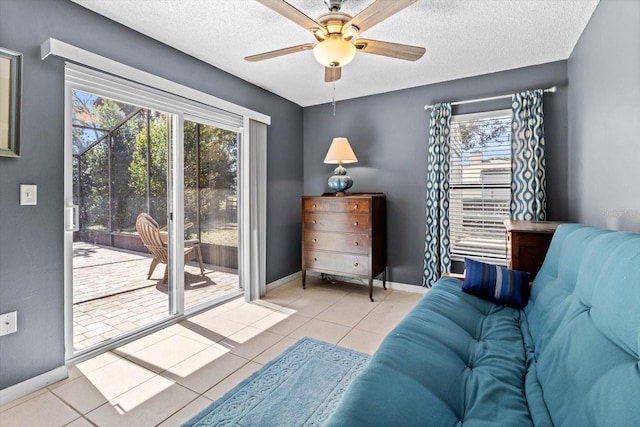 interior space featuring a ceiling fan, baseboards, and a textured ceiling