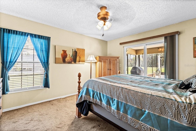 carpeted bedroom with access to exterior, a ceiling fan, baseboards, and a textured ceiling