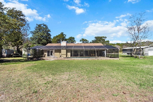 back of house with an outdoor pool, glass enclosure, a lawn, and a chimney