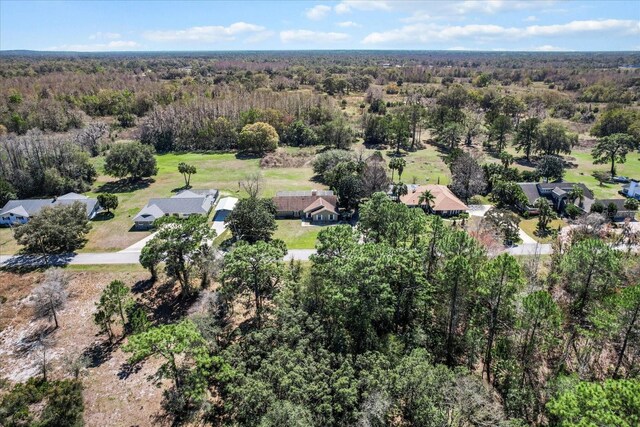 drone / aerial view featuring a view of trees