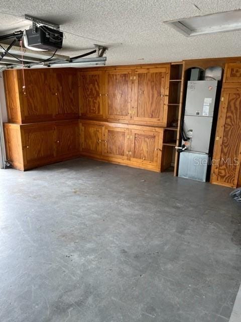 garage with a garage door opener and heating unit