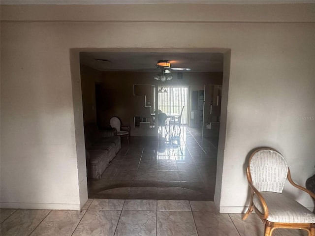 hallway with visible vents and baseboards