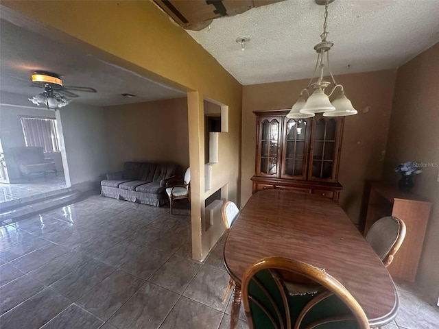 tiled dining space featuring ceiling fan and a textured ceiling