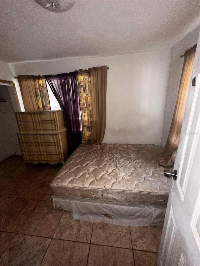 unfurnished bedroom with a textured ceiling