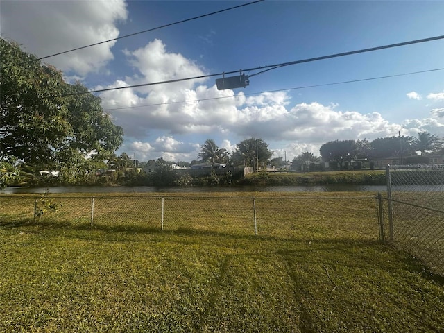 view of yard with fence and a rural view