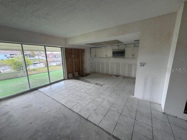 unfurnished room featuring a textured ceiling