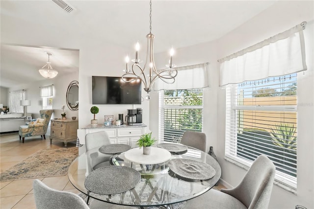 dining room with light tile patterned floors, visible vents, and an inviting chandelier