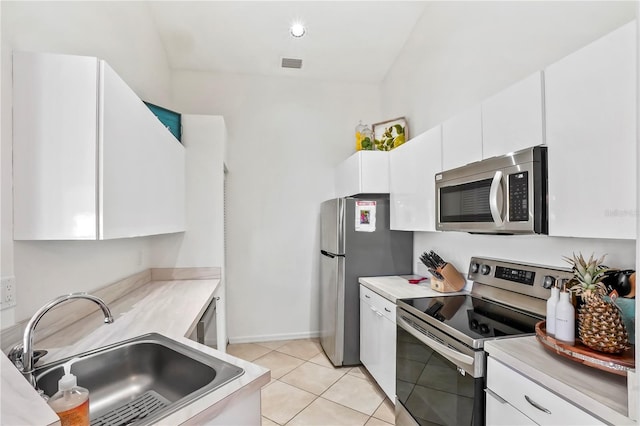 kitchen featuring light countertops, visible vents, appliances with stainless steel finishes, white cabinets, and a sink