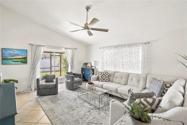 living room with vaulted ceiling, ceiling fan, and light tile patterned floors