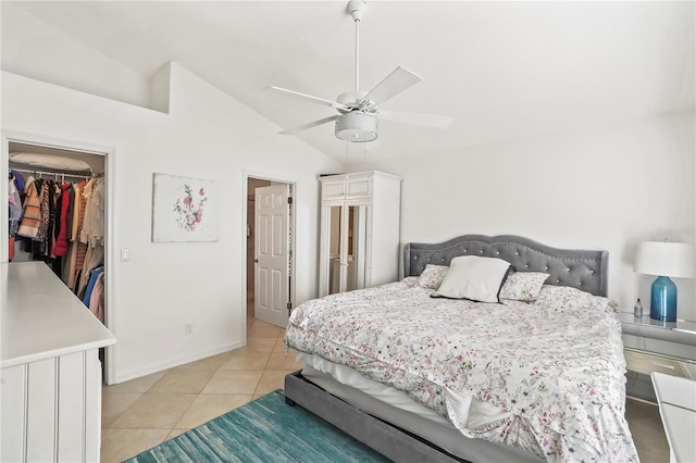 bedroom with light tile patterned floors, ceiling fan, a walk in closet, vaulted ceiling, and a closet