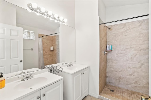 full bathroom with two vanities, a sink, and tiled shower