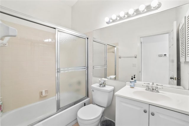 bathroom with toilet, bath / shower combo with glass door, and vanity