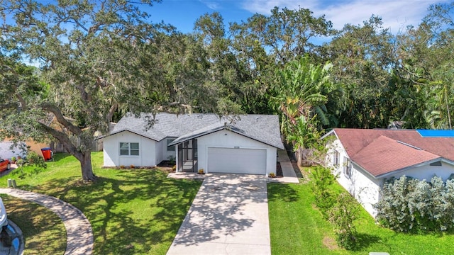 ranch-style house with an attached garage, driveway, roof with shingles, and a front yard