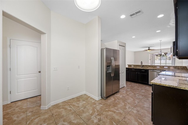 kitchen with visible vents, appliances with stainless steel finishes, light stone countertops, a sink, and recessed lighting