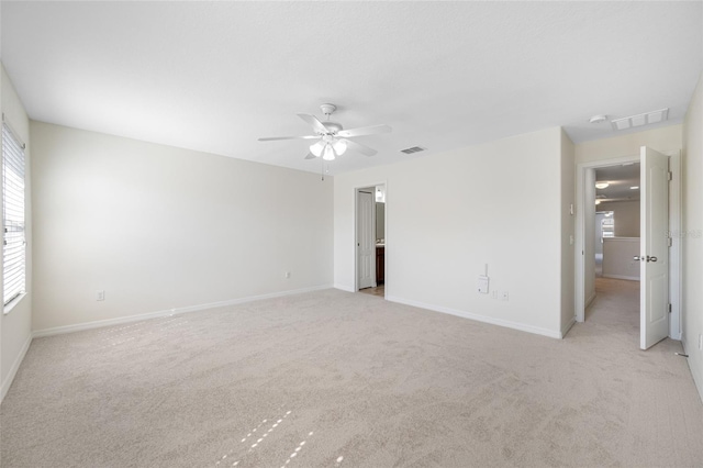 unfurnished room with light colored carpet and visible vents