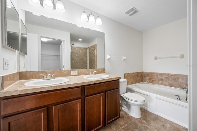 bathroom featuring a bath, a stall shower, a sink, and visible vents