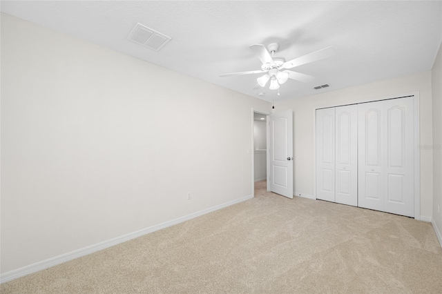 unfurnished bedroom featuring baseboards, visible vents, and light colored carpet