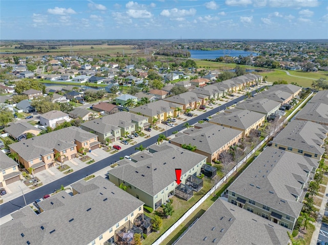 birds eye view of property featuring a water view and a residential view