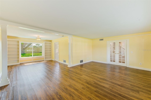 unfurnished living room featuring french doors, baseboards, visible vents, and wood finished floors