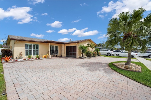 view of front of house with curved driveway and stucco siding