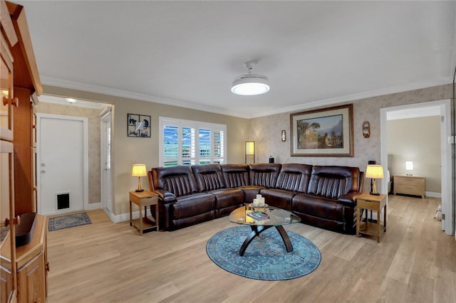 living area featuring light wood-style flooring, ornamental molding, and baseboards