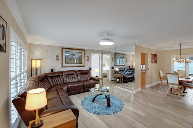 living area featuring crown molding, baseboards, a chandelier, and light wood-style floors